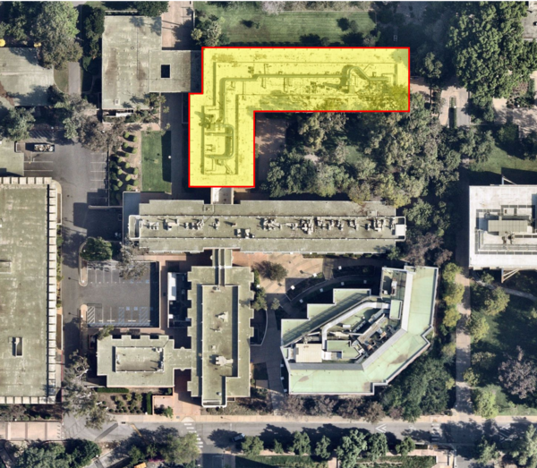 An aerial view of a building complex, with the L-shaped north section of Spieth Hall highlighted in semi-transparent yellow with a red outline.